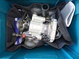 a blue container filled with a water pump and other items