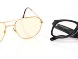 pair of black and gold glasses on a white background