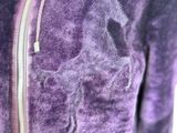a close up of a purple jacket with a horse on it