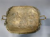 gold plate with a picture of a man and a woman on it