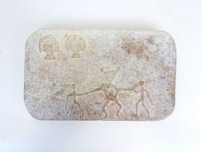 a stone with a picture of a man and a horse on it