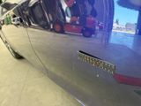 a close up of a car ' s door handle with a sticker on it