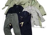 several jackets and pants are laid out on a white surface