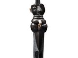 statue d'un homme assis sur un socle, un couteau à la main