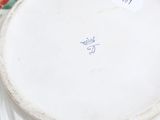 a white plate with a flower design on it on a table