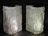 two glass vases with frosted glass on a black surface