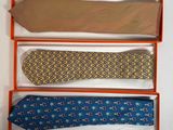 three ties are in a box on a white surface