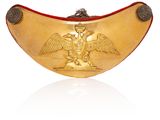 an image of a gold plate with a bird and a snake on it