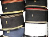 several hats stacked on top of each other on a white surface