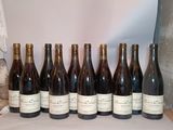 several bottles of wine are lined up on a table