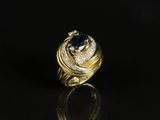 a close up of a gold ring with a sapphire and diamonds