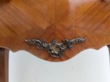 a wooden table with a metal handle on it