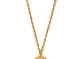 a gold necklace with a ruby stone on a chain