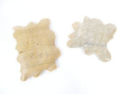 two pieces of stone with writing on them