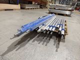 a pile of pipes sitting on a pallet in a warehouse