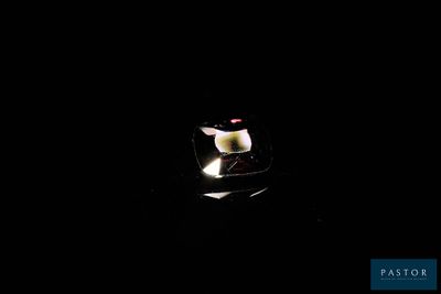 a candle that is lit up in the dark