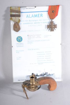 a picture of a miniature gun with a medal on it