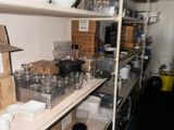 a shelf full of dishes and bowls in a kitchen