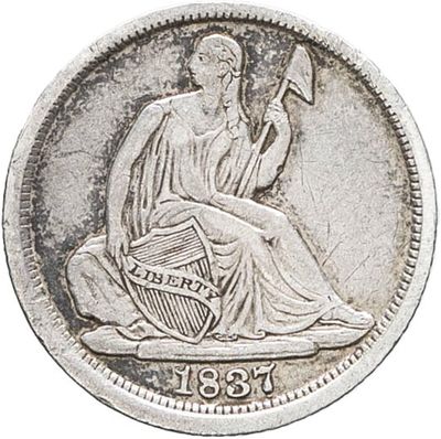 a silver coin with a woman sitting on top of it