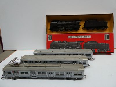 three model trains sitting on a table next to a box