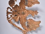 a gold brooch with a bird on it