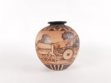 a vase with a painting on it on a white surface