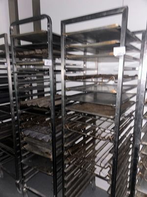 many trays of food that are on a rack