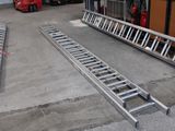 two ladders that are on the ground in front of a building