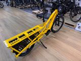 a yellow bicycle with a basket on the back of it