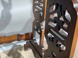 a close up of a chair made of wood and metal
