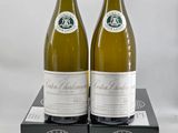 two bottles of white wine sitting on top of a black box