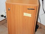 an image of a small wooden cabinet in the corner of a room