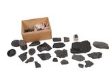 a box of rocks and stones on a white surface