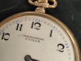 a close up of a pocket watch on a table