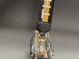 a black purse with a yellow and yellow strap