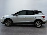 the white suv is parked on the concrete floor in the room