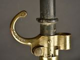 a close up of a brass colored umbrella with a handle