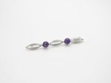 a pair of silver and amethtite earrings with purple stones