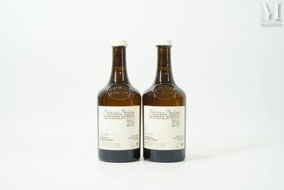 two bottles of wine sitting next to each other on a white surface
