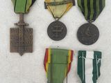 several medals and medals are displayed on a white surface