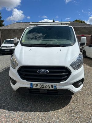 ford transit van parked in a parking lot with other vehicles in the background