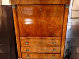 a wooden cabinet that has a marble top on it