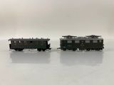 two toy trains sitting side by side on a white surface