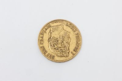 a close up of a gold coin on a white surface