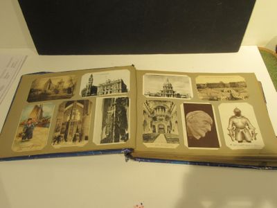 an open book on a table with pictures on it