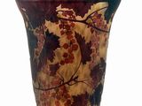 a vase with a floral design on it sitting on a table