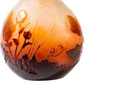 a vase that has a brown and white design on it