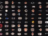 many different types of rings on display in a display case