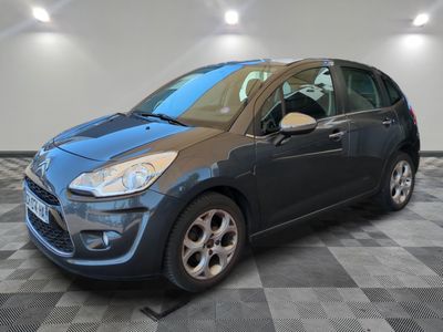 a blue car is parked in a room with a checkered floor