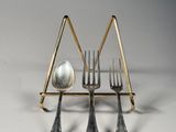 three forks and spoons in a triangle shape with a spoon in the middle